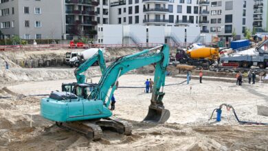 Civil engineers reviewing blueprints at an active construction site