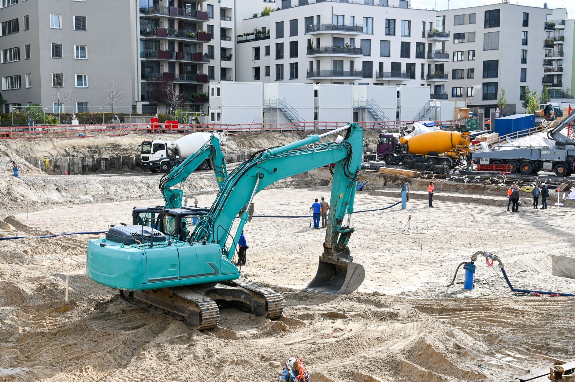 Civil engineers reviewing blueprints at an active construction site