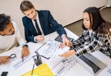 Two professionals reviewing commercial insurance documents at an office desk