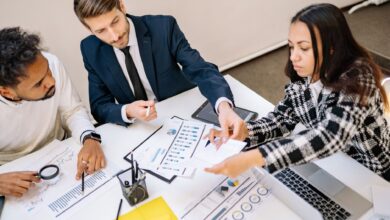 Two professionals reviewing commercial insurance documents at an office desk