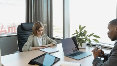Recruiter reviewing resumes at a desk in a regional staffing office