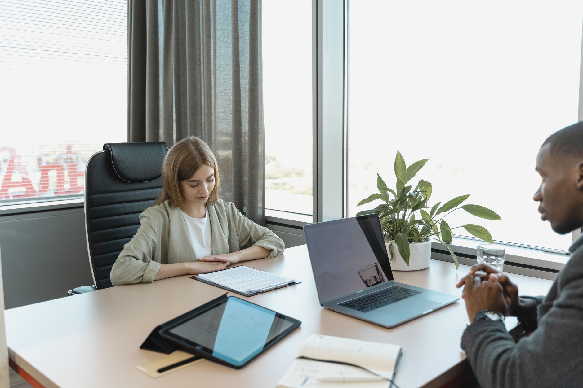 Recruiter reviewing resumes at a desk in a regional staffing office