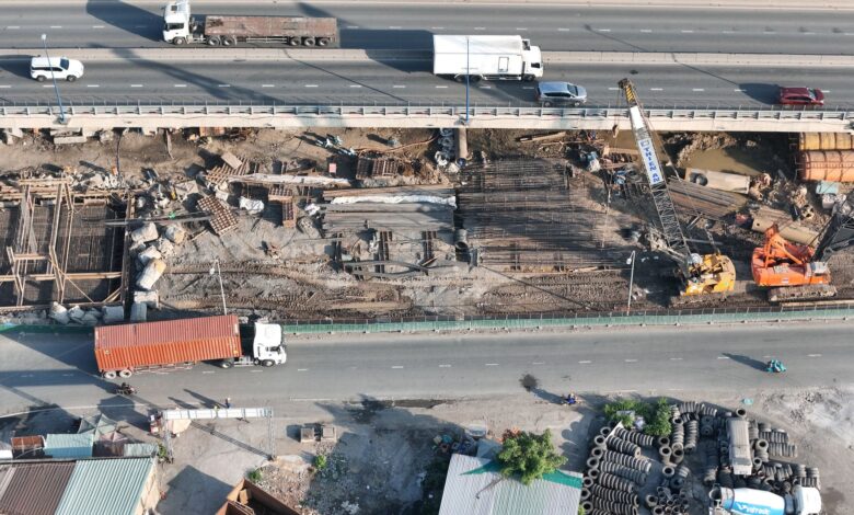 Aerial view of a large commercial construction site with cranes and building frameworks