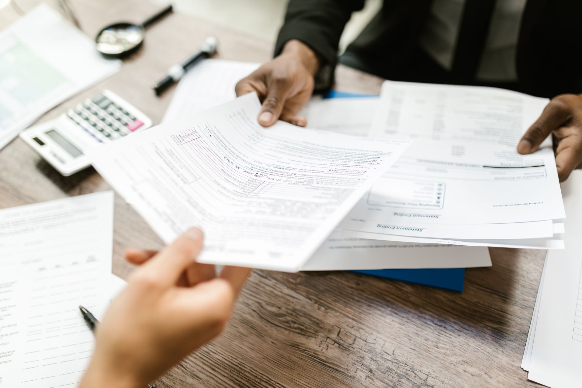 Insurance policy documents and pen on an office desk