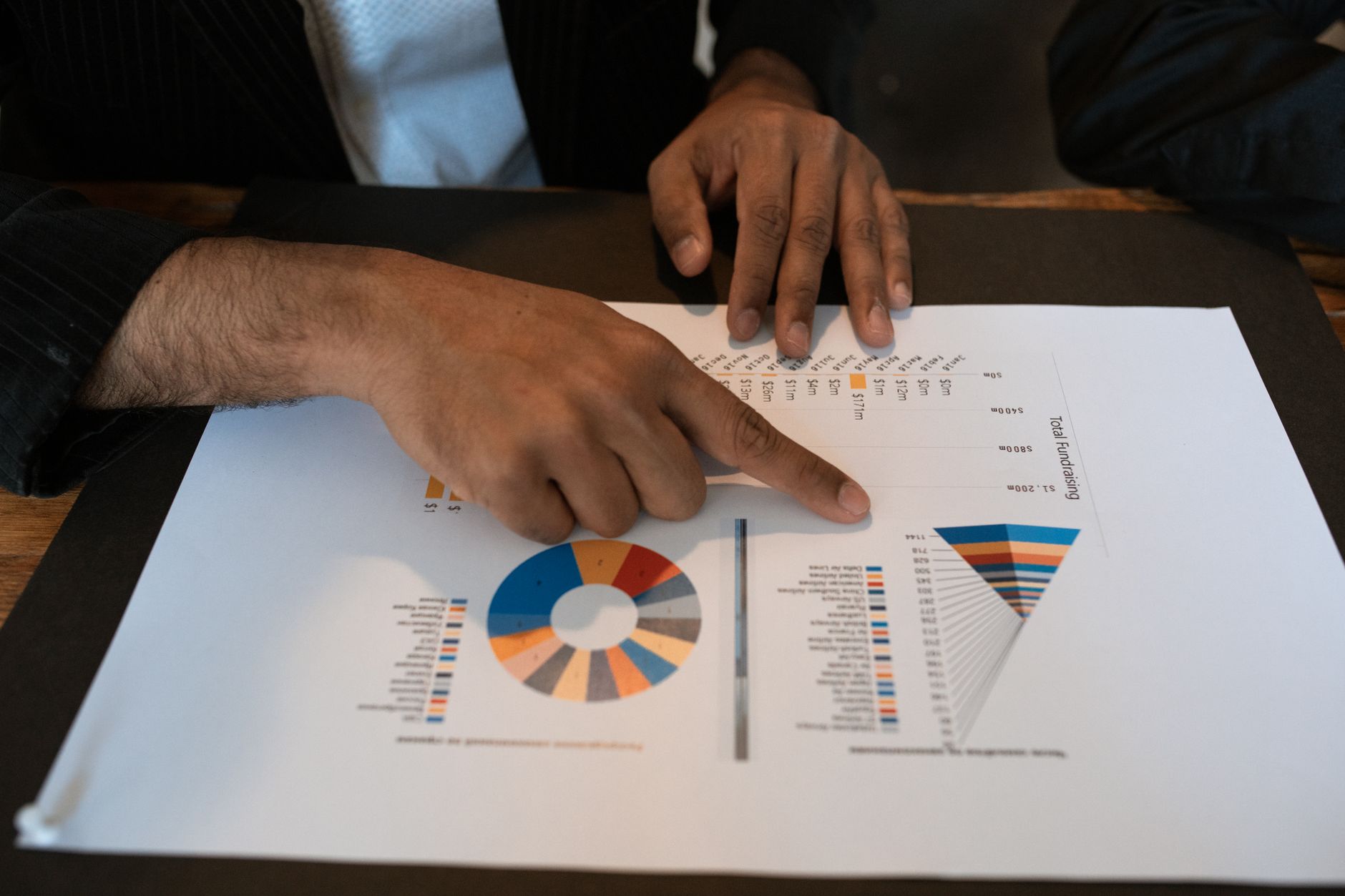 Real estate professional reviewing property data and documents on a laptop