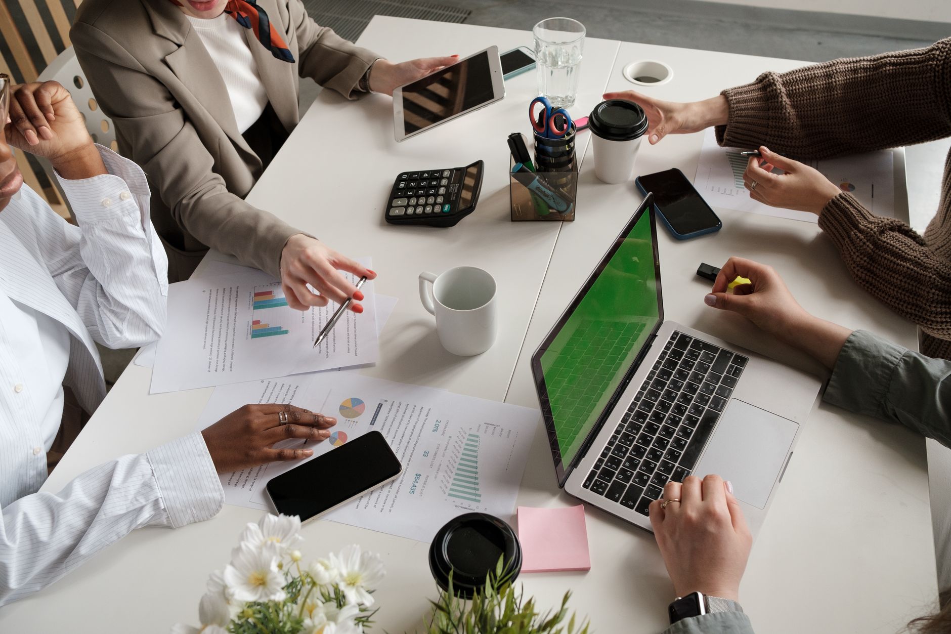 Professionals reviewing documents around a conference table during a business meeting