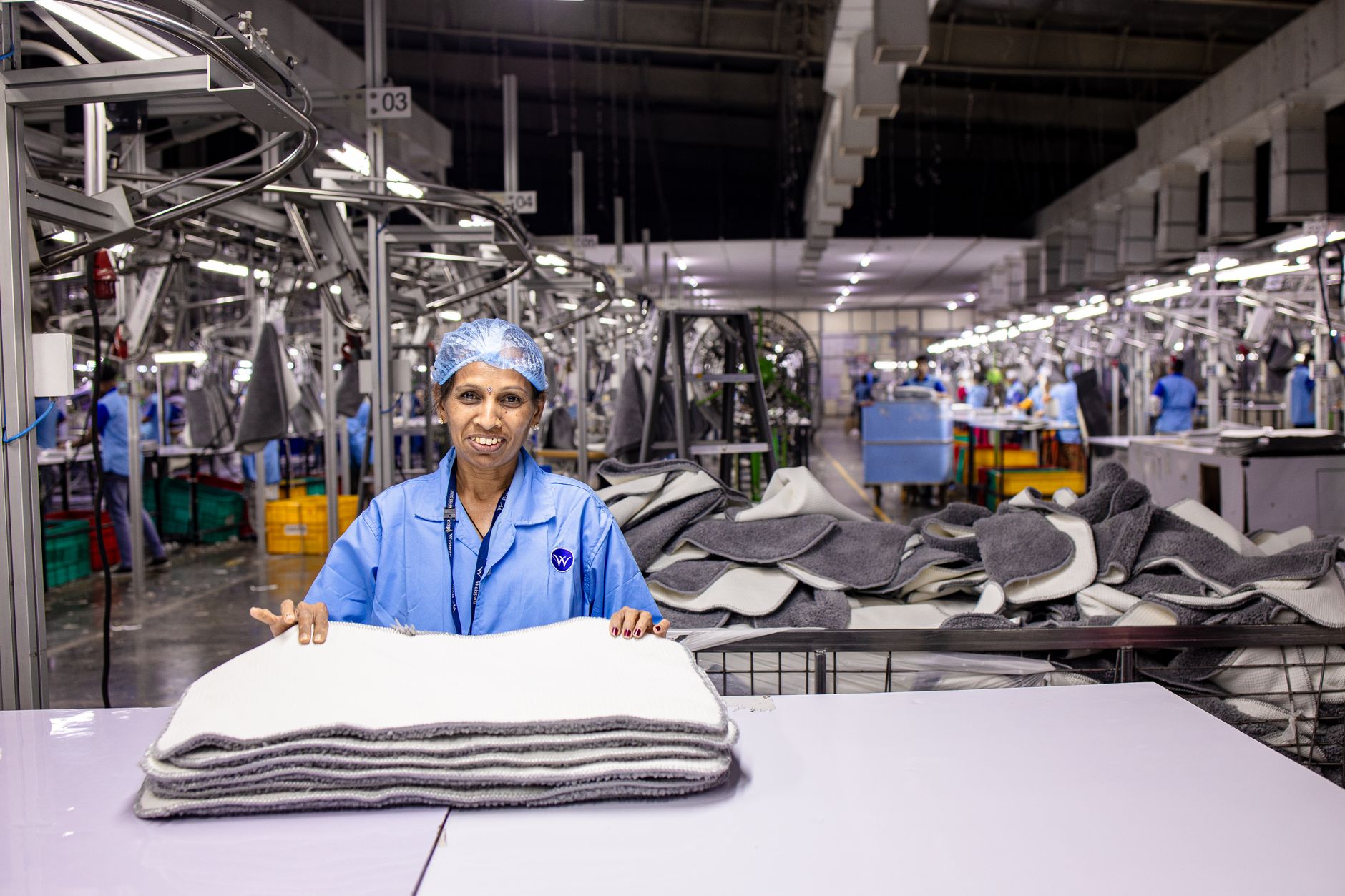 Workers on a manufacturing assembly line in a light industrial production facility