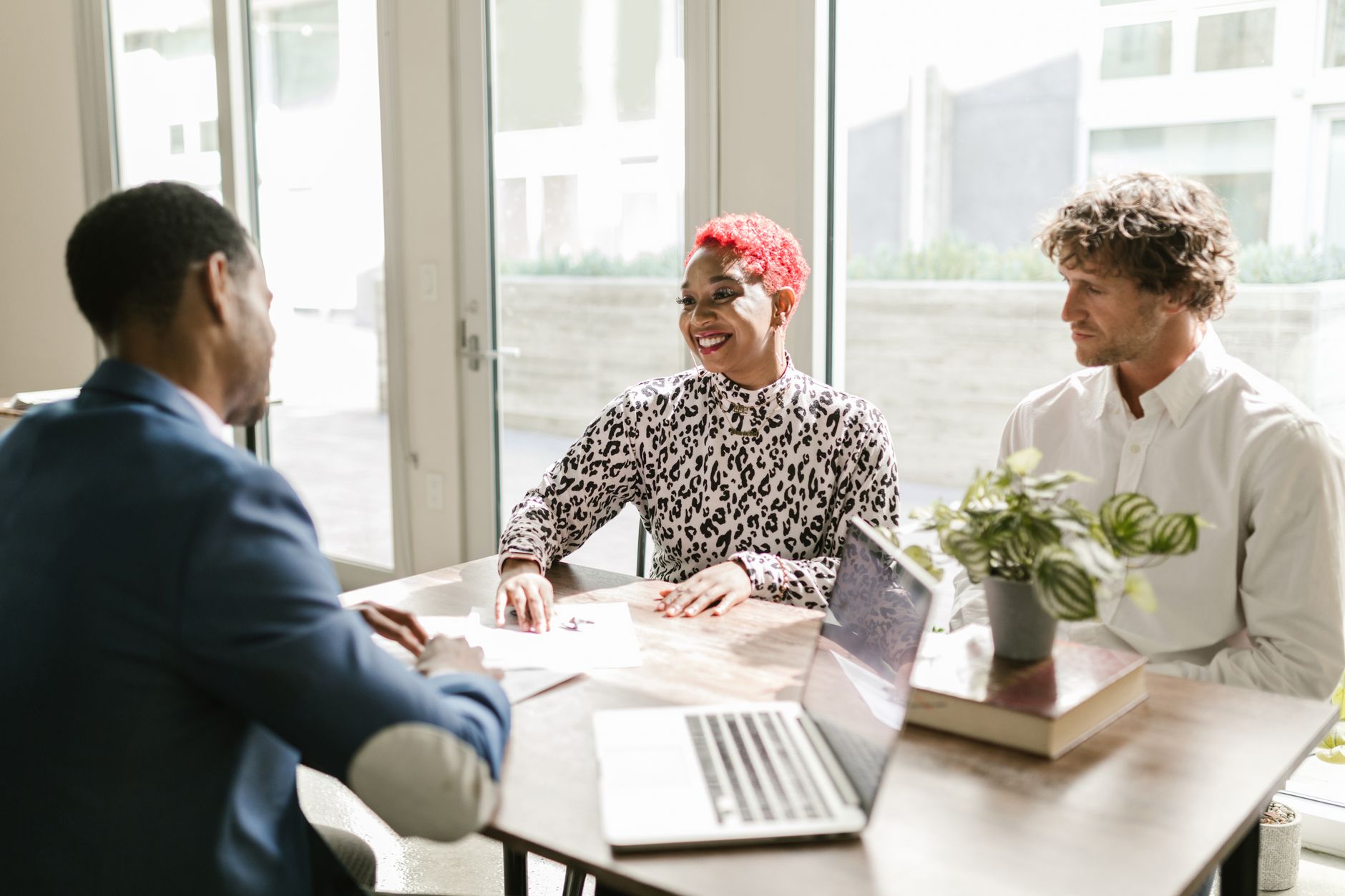 Business professionals reviewing financial documents in a bank conference room