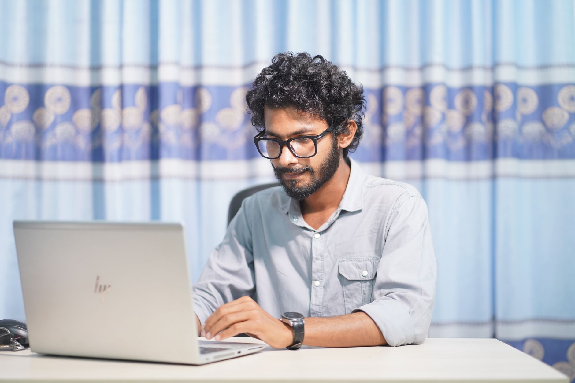 Software developer working remotely on a laptop from a home office