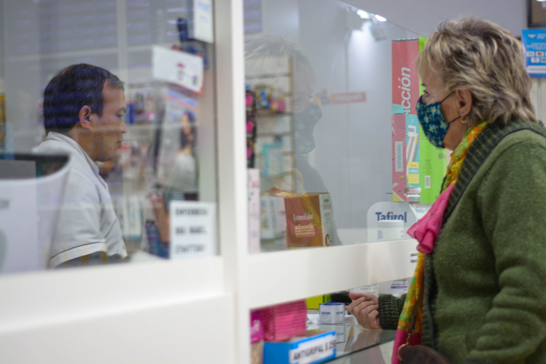 Patient checking in at a pharmacy-based health clinic counter