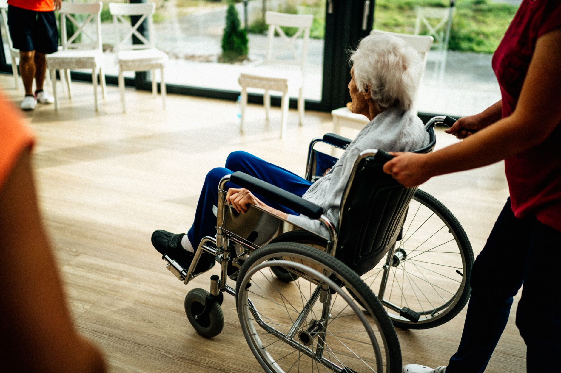 An older adult sitting alone at home, representing patients affected by home care provider shortages