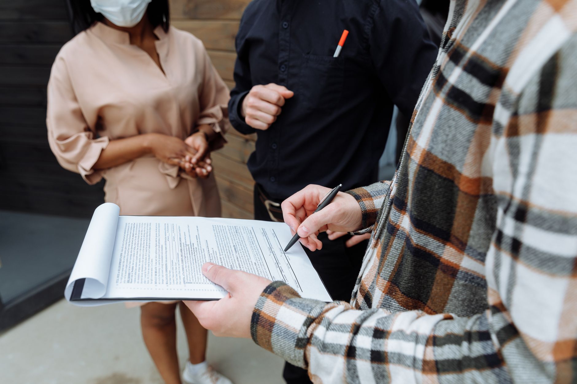 Person signing a business contract document at a desk