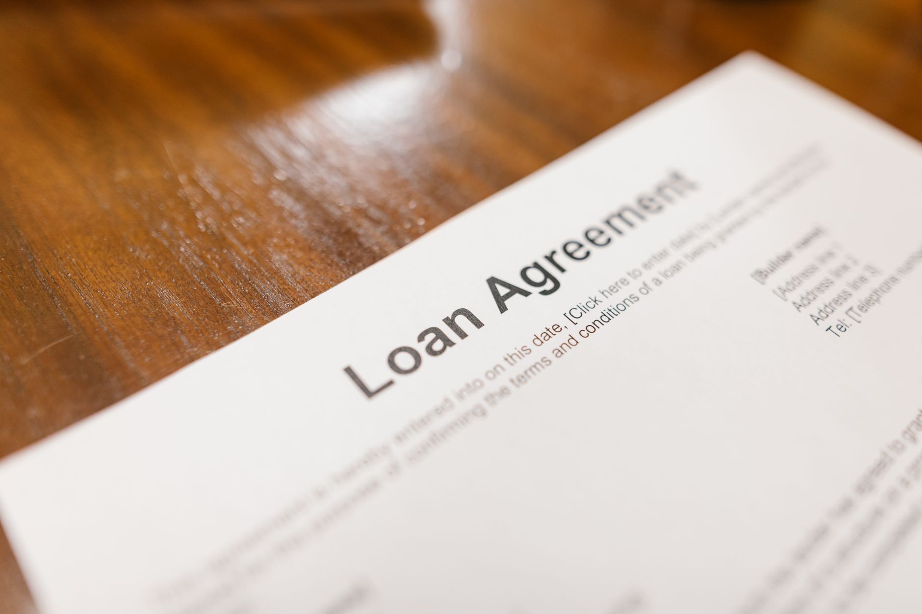 Loan application documents and paperwork spread across an office desk