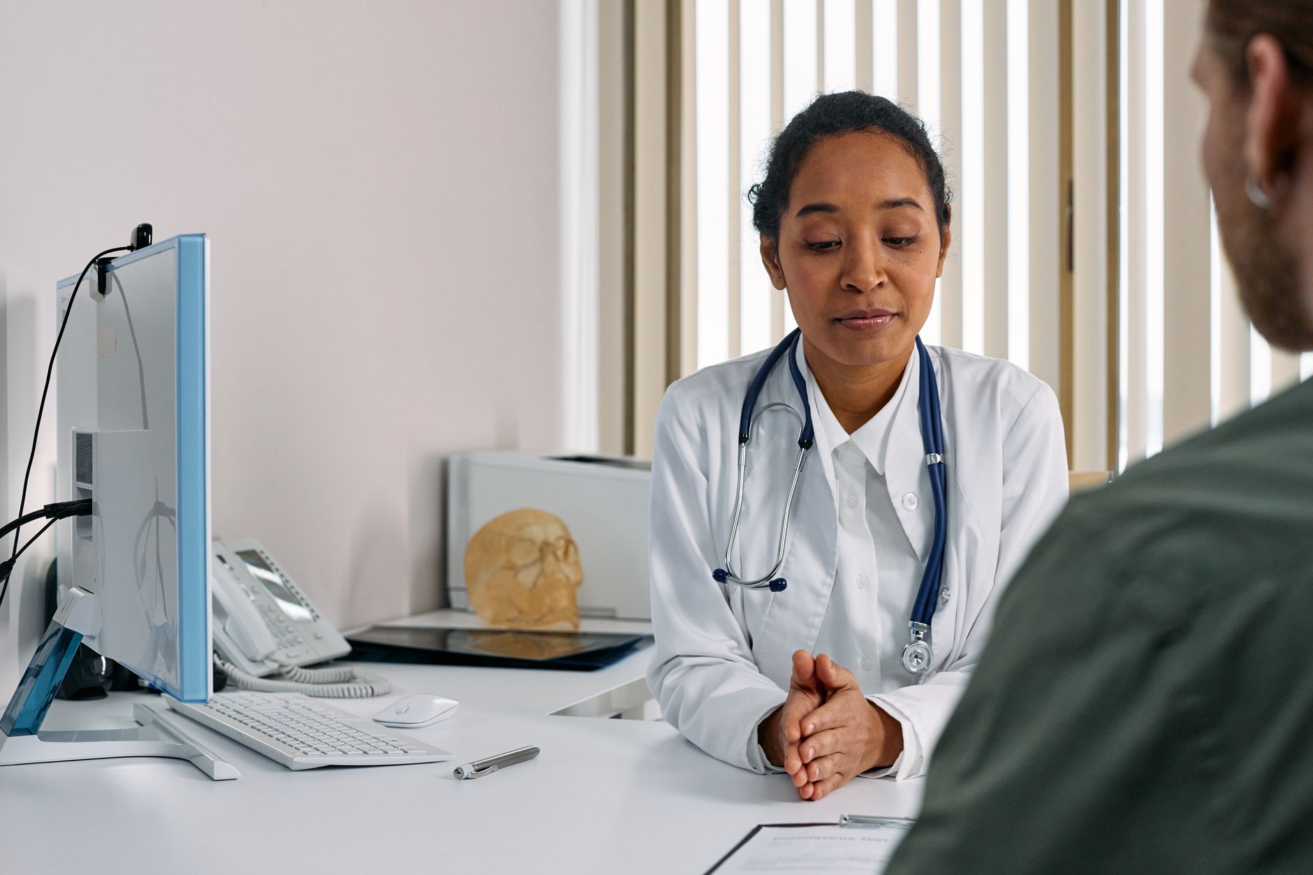 Oncologist speaking with a patient during a medical consultation