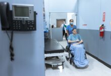 A quiet hallway inside a skilled nursing facility with medical equipment visible