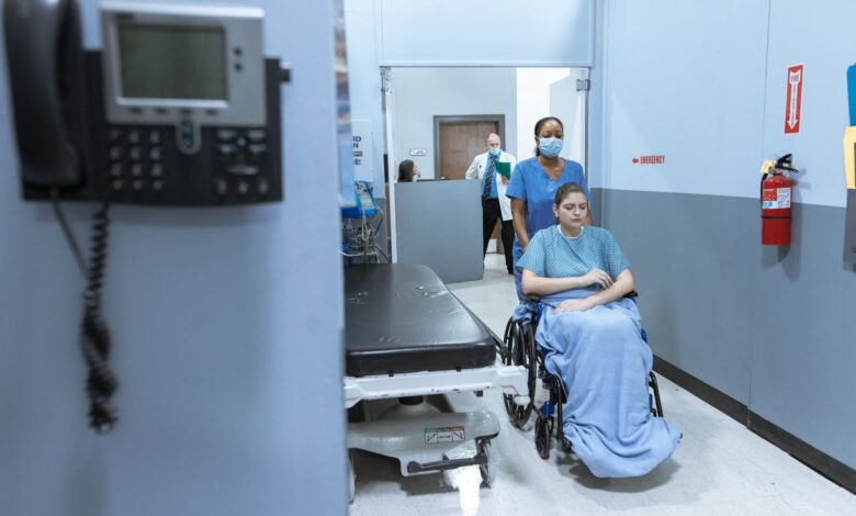 A quiet hallway inside a skilled nursing facility with medical equipment visible