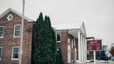 Exterior of a traditional funeral home building with stone facade and quiet entrance