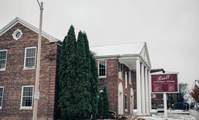 Exterior of a traditional funeral home building with stone facade and quiet entrance