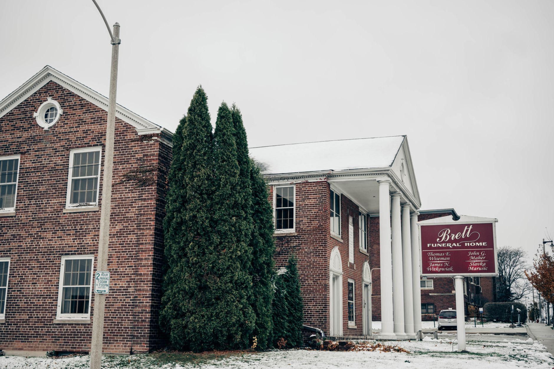 Exterior of a traditional funeral home building with stone facade and quiet entrance