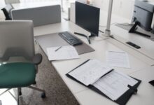 Commercial real estate appraiser reviewing property documents at a desk