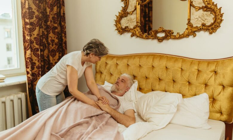 A home health aide assisting an elderly patient in a residential setting