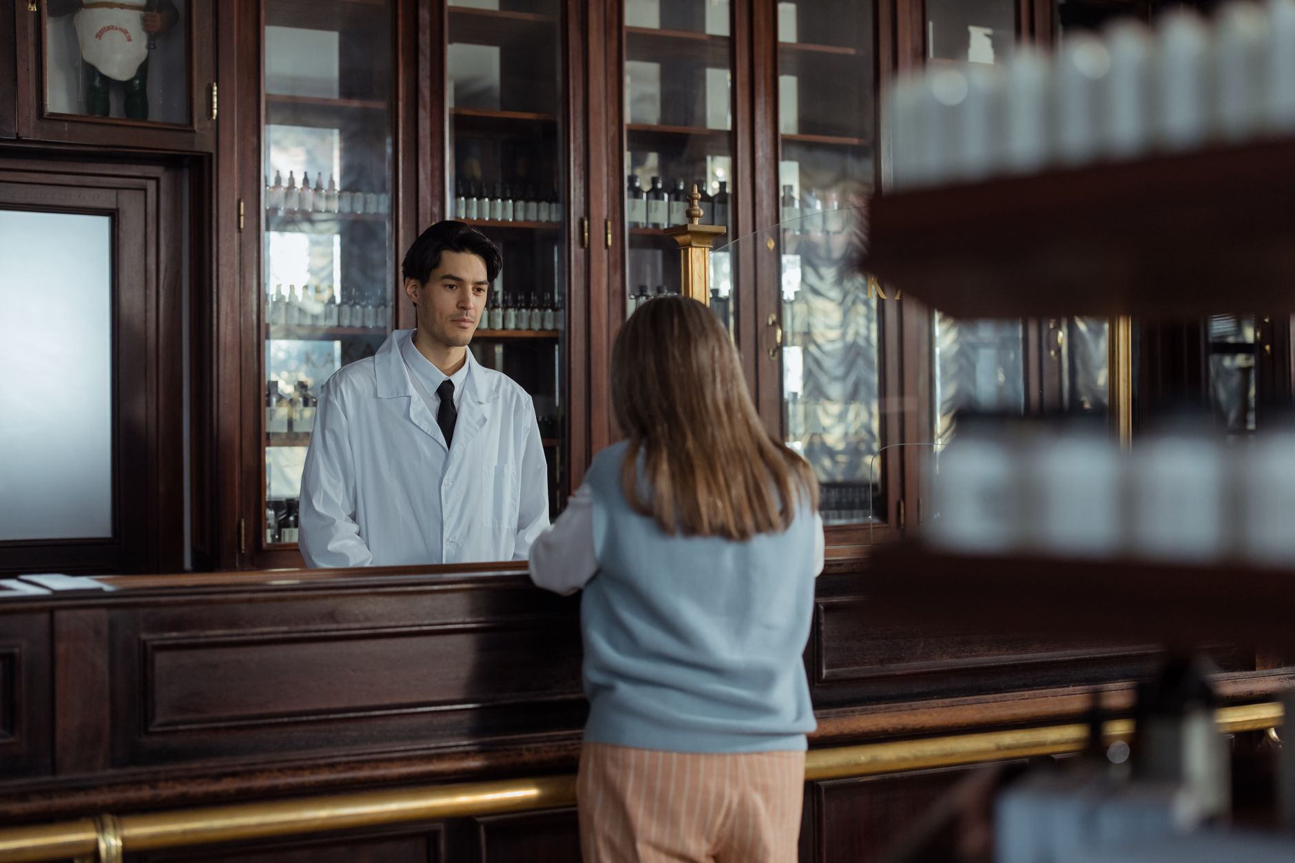 Interior of a pharmacy with shelves of medications and a clinical workspace