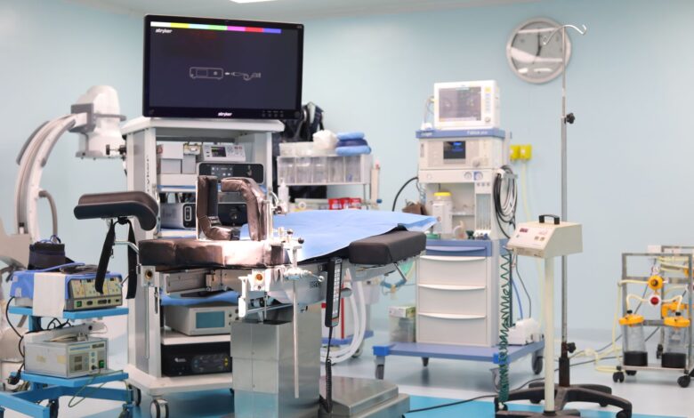 A modern hospital operating room prepared for a surgical procedure with anesthesia equipment visible