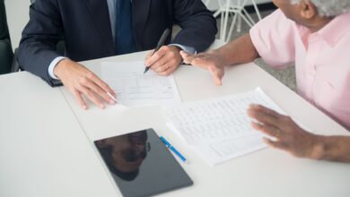 Financial advisor meeting with clients at a conference table in a modern office