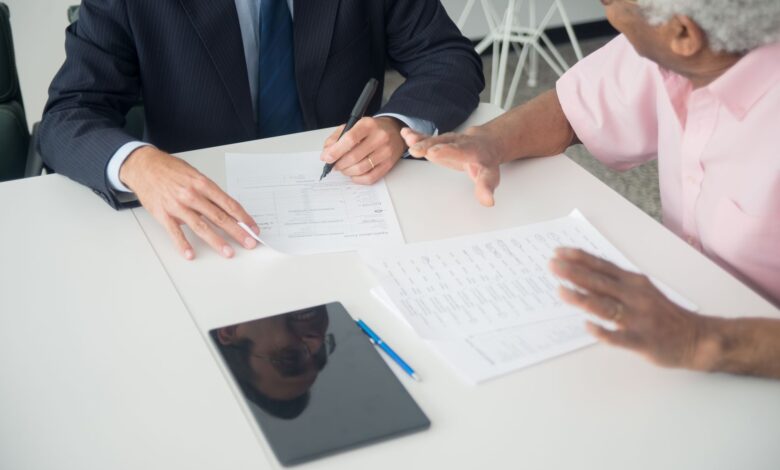 Financial advisor meeting with clients at a conference table in a modern office