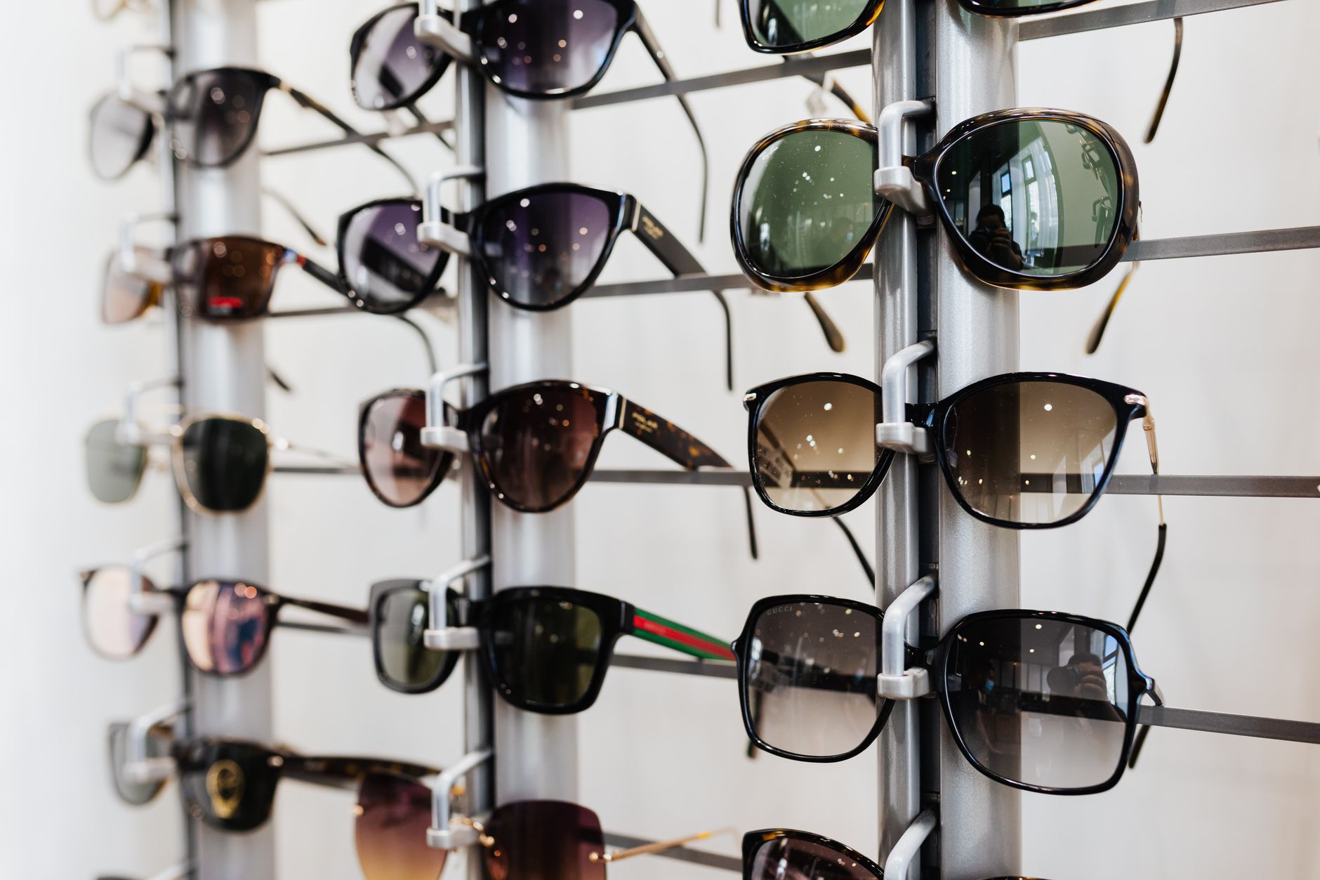 Interior of an optical retail store with eyeglass frames displayed on shelves