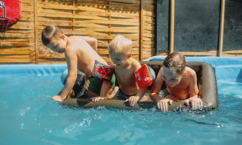 Children taking swimming lessons in an indoor pool at a local swim school