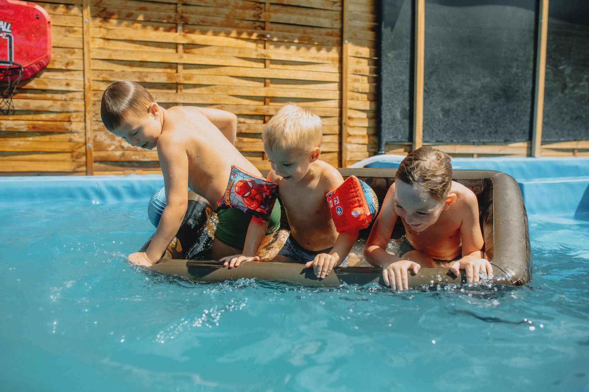 Children taking swimming lessons in an indoor pool at a local swim school