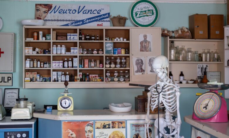 A modern pharmacy interior showing prescription medication shelves and counter