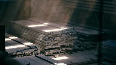 Large steel warehouse interior with stacked metal coils and industrial shelving