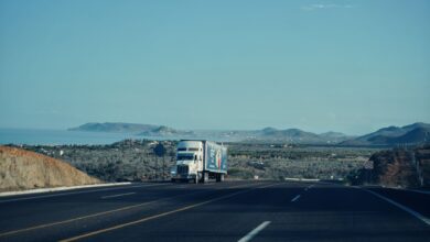 A commercial freight truck driving on a highway, representing regional shipping logistics