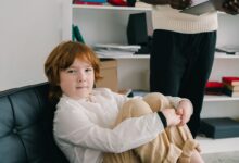 A speech therapist working one-on-one with a young child in a clinical office setting