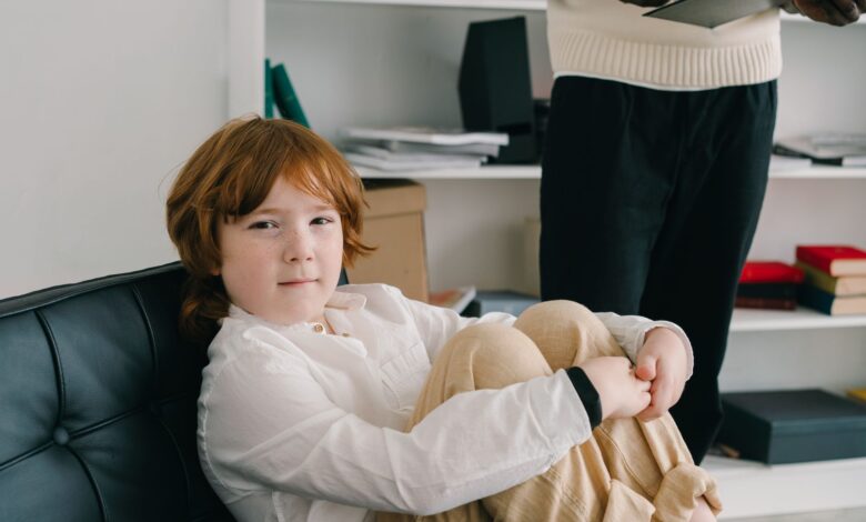 A speech therapist working one-on-one with a young child in a clinical office setting