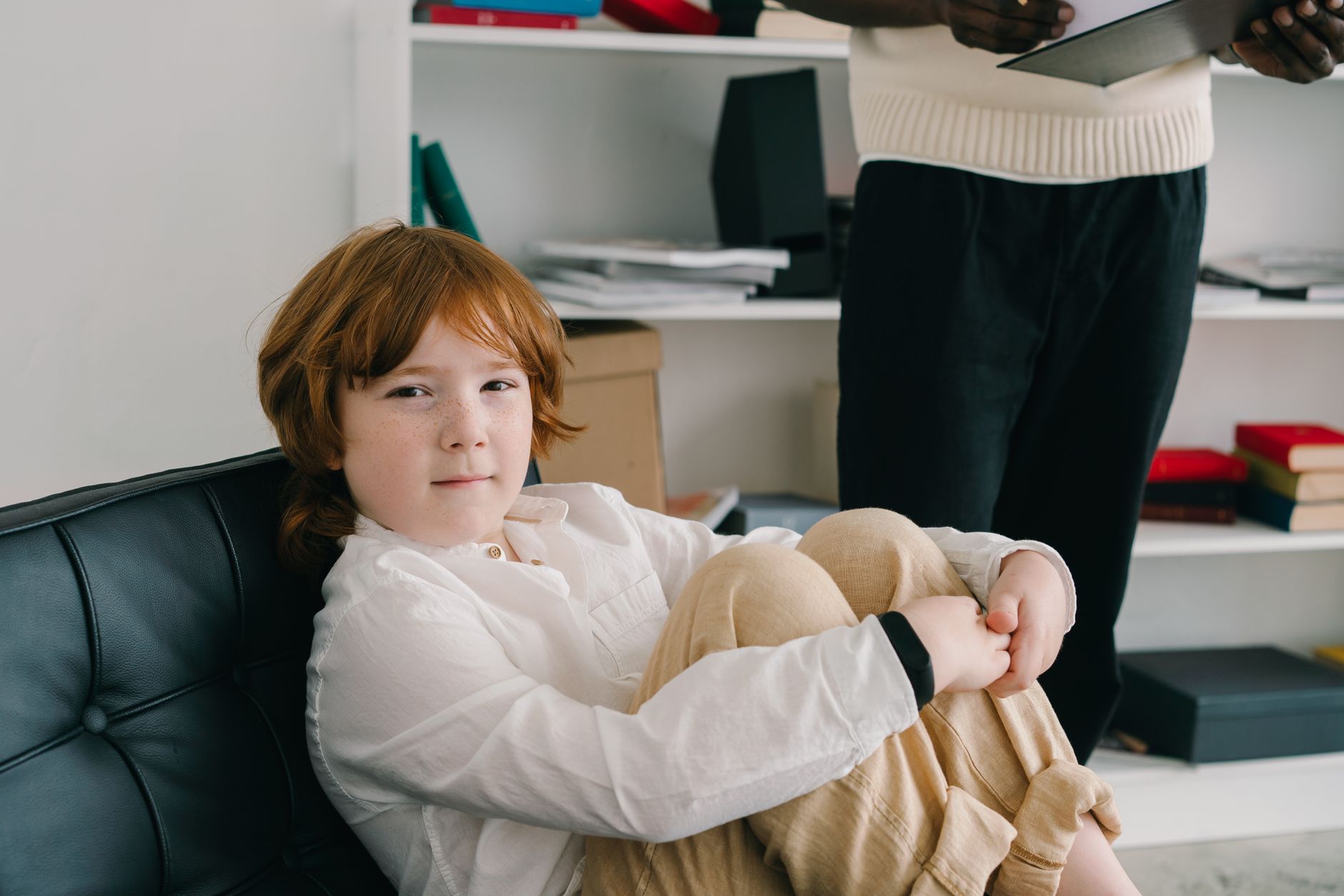 A speech therapist working one-on-one with a young child in a clinical office setting