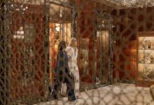 Modern elevator interior with stainless steel doors and control panel
