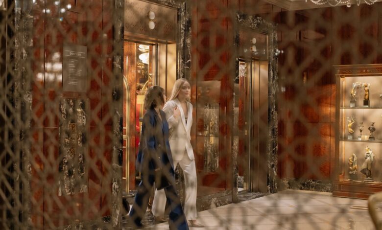Modern elevator interior with stainless steel doors and control panel
