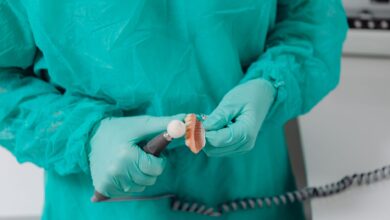 A dental lab technician working on a prosthetic crown at a regional dental laboratory