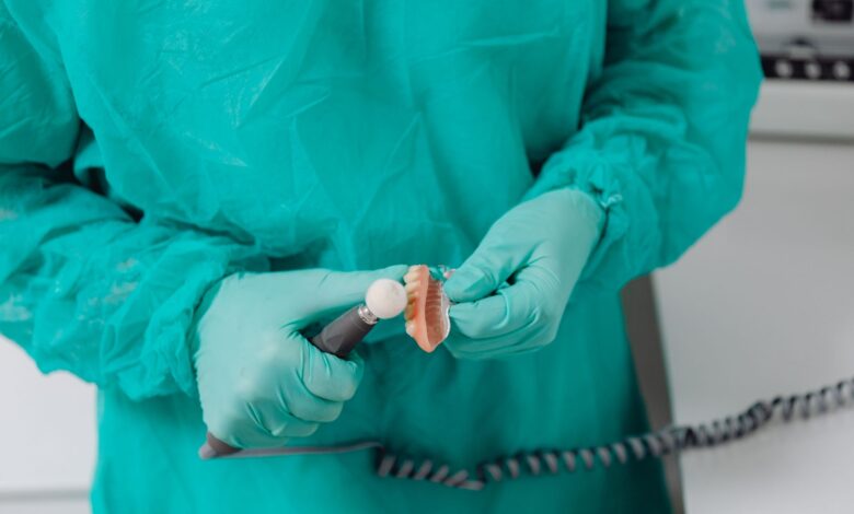 A dental lab technician working on a prosthetic crown at a regional dental laboratory
