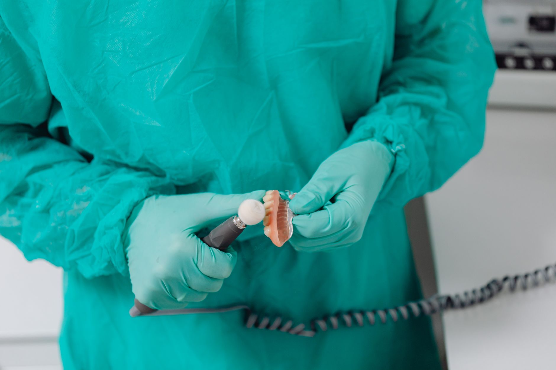A dental lab technician working on a prosthetic crown at a regional dental laboratory