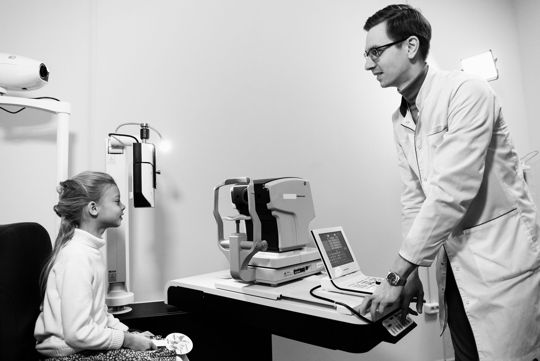 A patient receiving an eye examination at a modern ophthalmology clinic