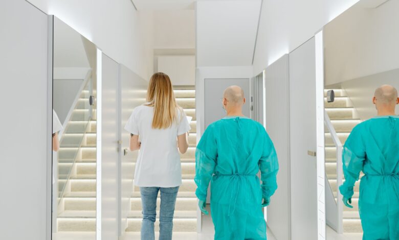 A clean, modern ambulatory surgery center corridor with medical equipment and overhead lighting