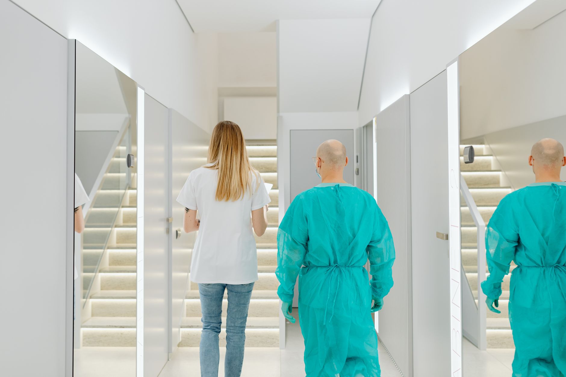 A clean, modern ambulatory surgery center corridor with medical equipment and overhead lighting