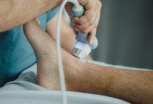 A physical therapist working with a patient in a modern outpatient clinic
