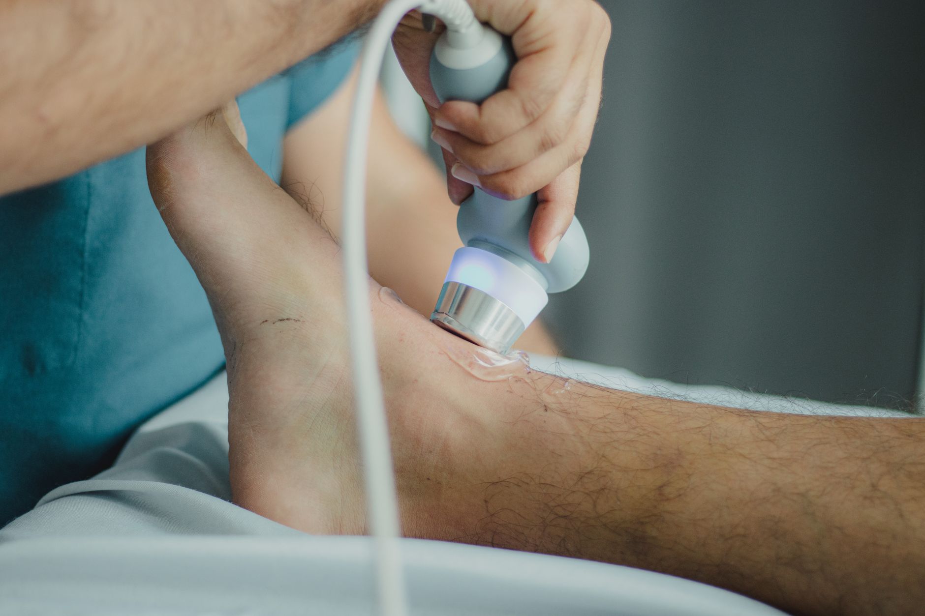 A physical therapist working with a patient in a modern outpatient clinic