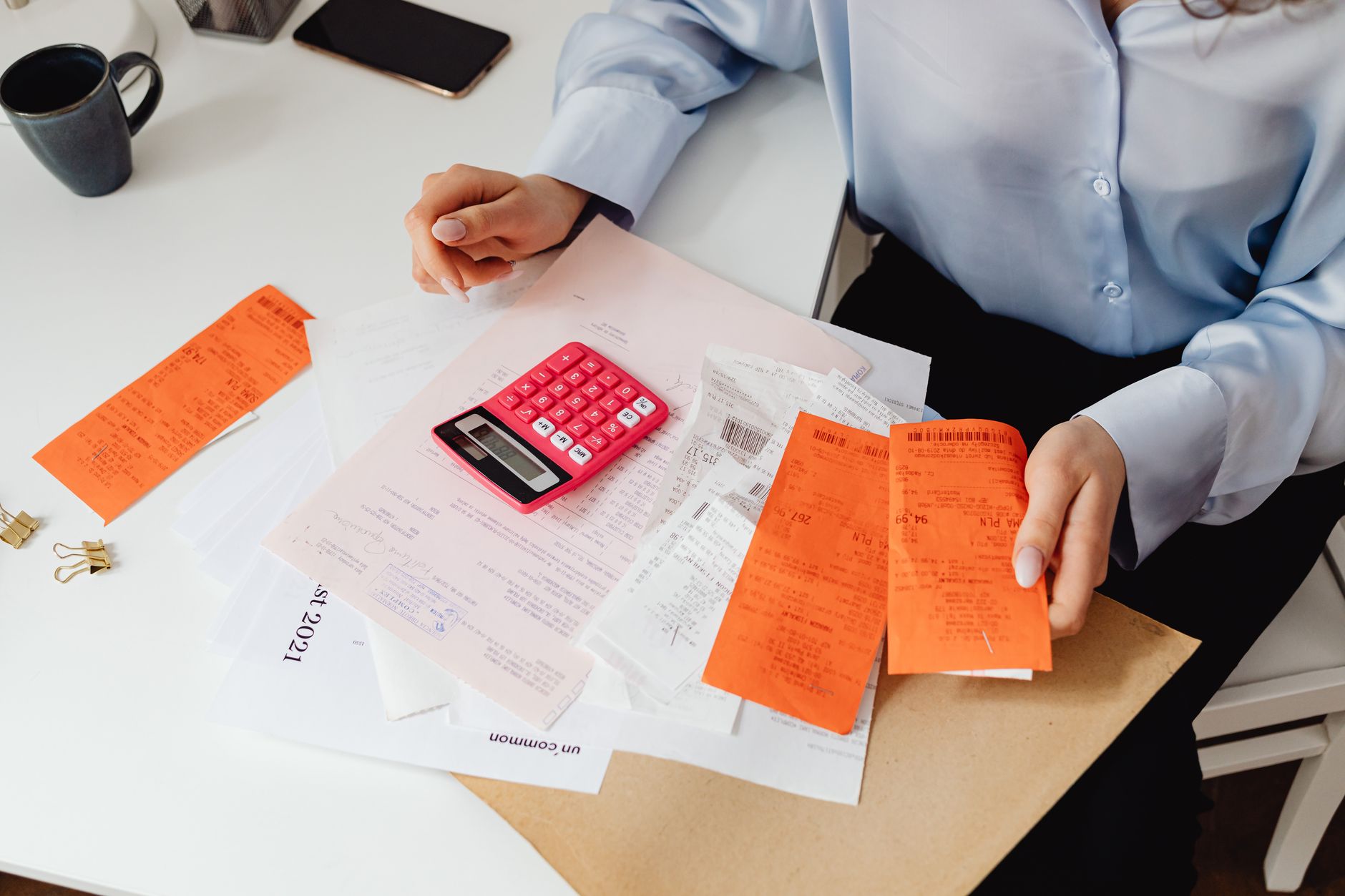 Healthcare administrator reviewing medical billing documents at a desk