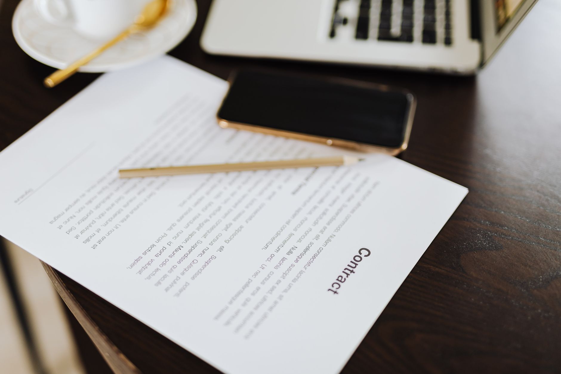 Two professionals reviewing documents during a business deal meeting